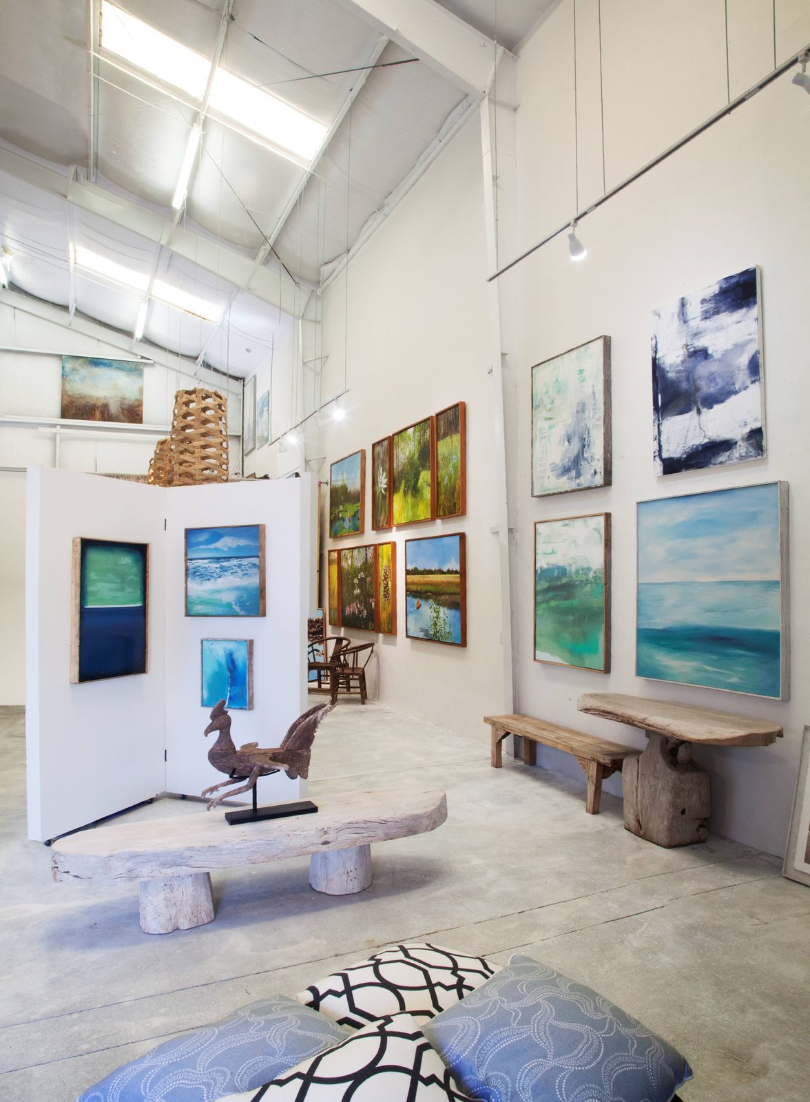 Inside the gallery: paintings hung on white walls